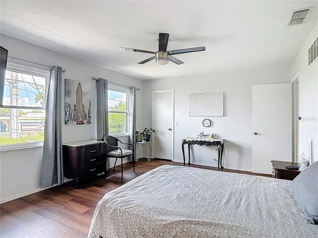 a spacious bathroom with a granite countertop sink a toilet and a shower