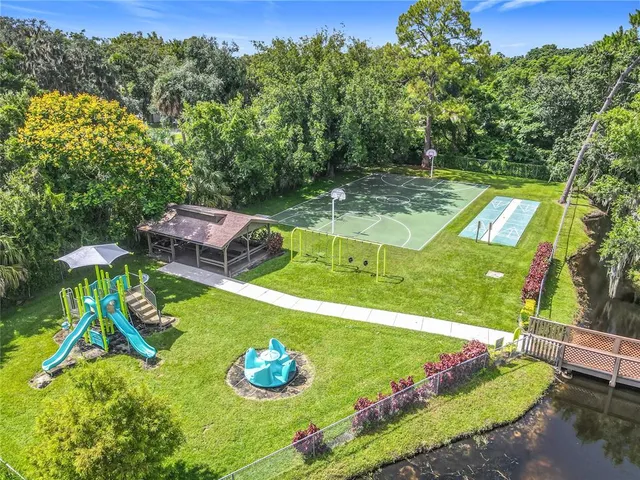 an aerial view of a house with a garden and swimming pool