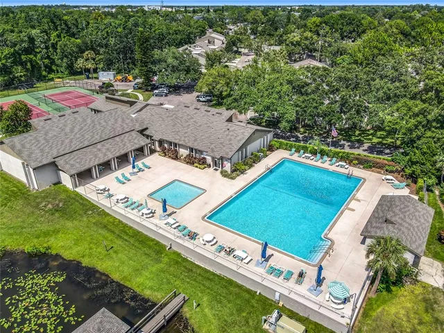 an aerial view of residential houses with outdoor space and river