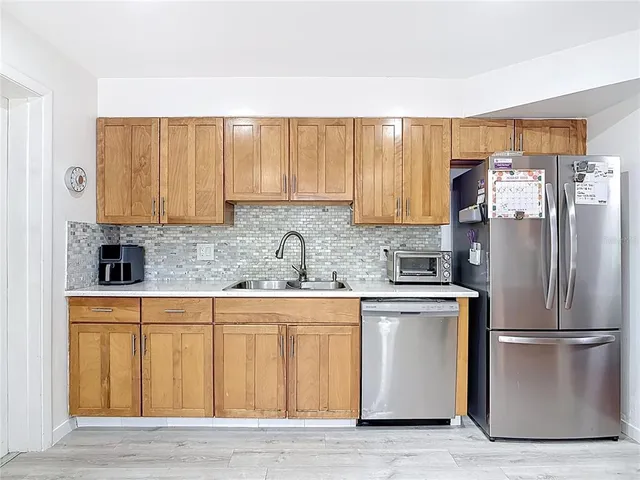 a kitchen with stainless steel appliances granite countertop a sink a stove and cabinets