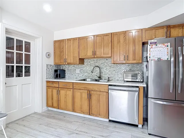 a kitchen with stainless steel appliances granite countertop a sink a stove and cabinets