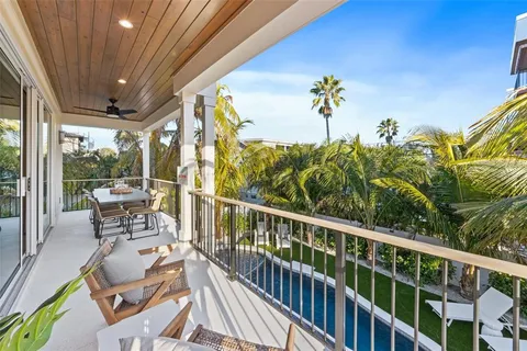 a bedroom with a bed and a potted plant on the dresser