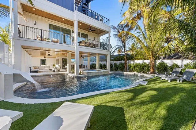 a living room with furniture a window and a potted plant
