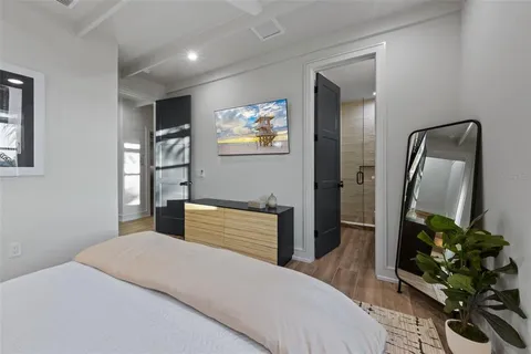 a bathroom with a double vanity sink a toilet and shower