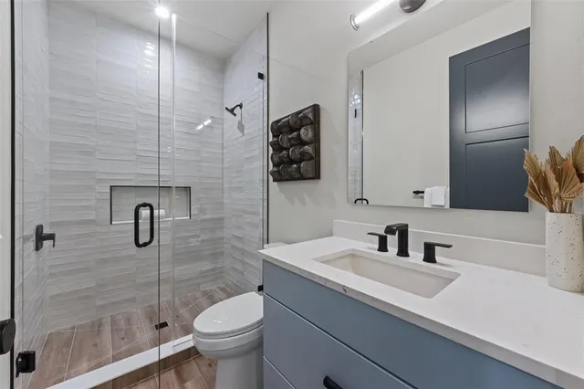 a bathroom with a sink toilet and shower