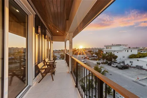 a view of a balcony with chair and wooden floor