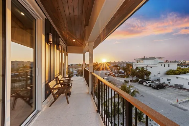 a view of a balcony with chair and wooden floor