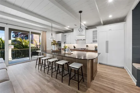 a kitchen with stainless steel appliances granite countertop a sink stove and wooden floor