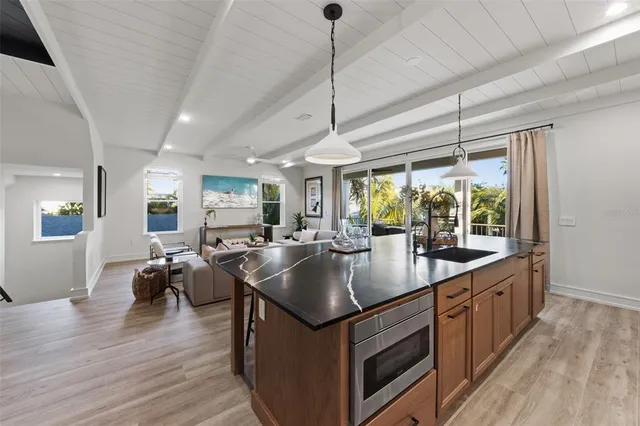 a kitchen with stainless steel appliances cabinets and a window