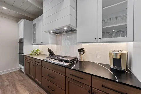 a kitchen with stainless steel appliances granite countertop a refrigerator and a stove top oven