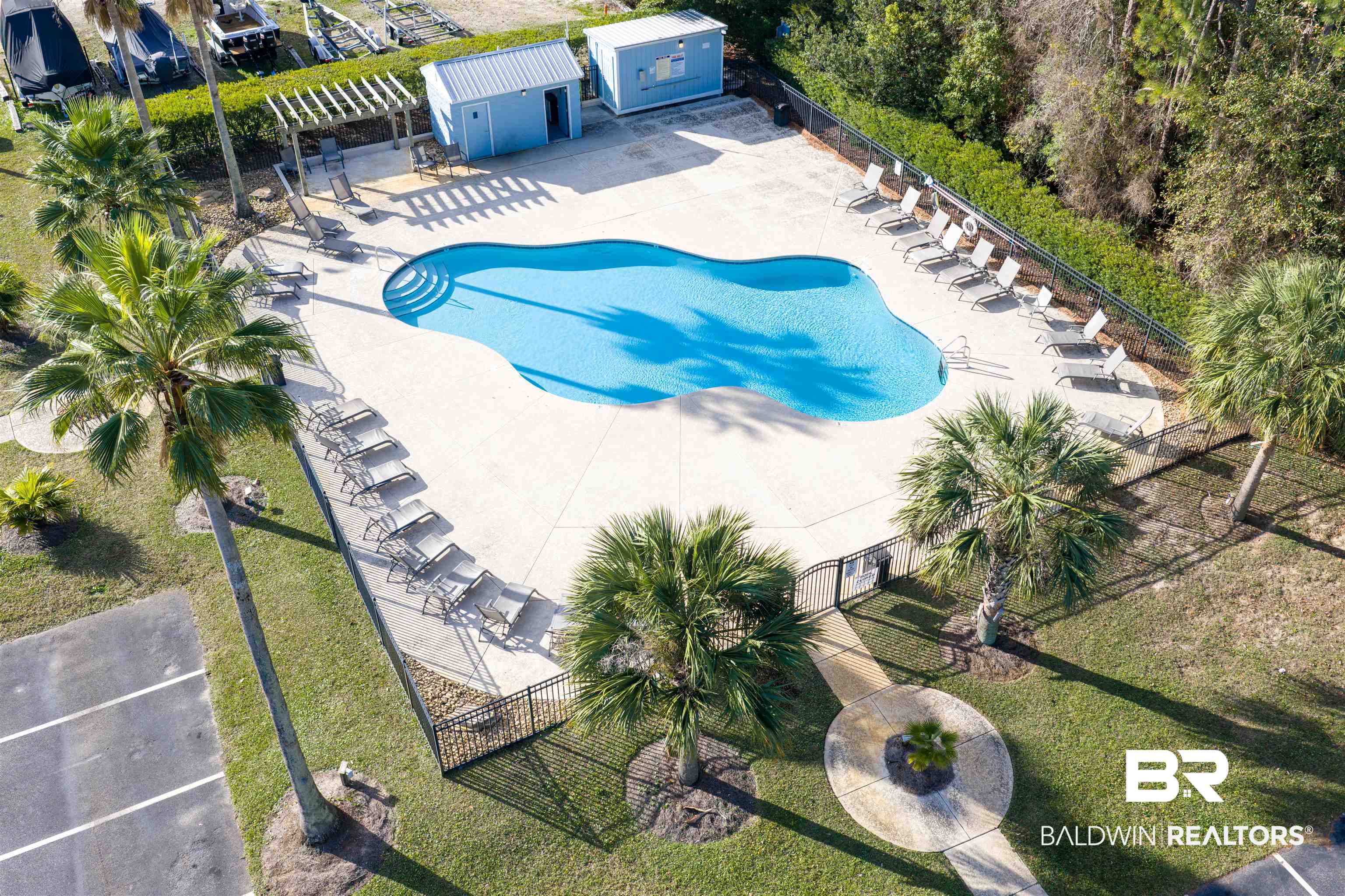 25861 Canal Road, Unit 3 Orange Beach, AL 36561 - Photo 38 of 40 Community pool with a patio and a shed