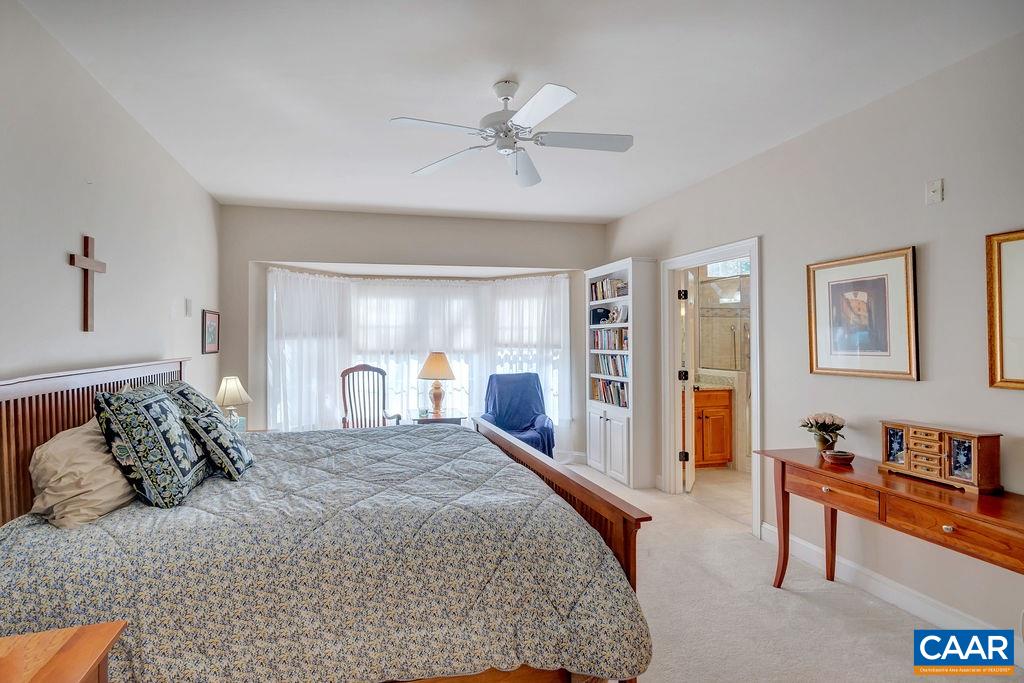 1990 River Inn Lane Charlottesville, VA 22901 - Photo 18 of 48 a bedroom with a large bed and a chandelier