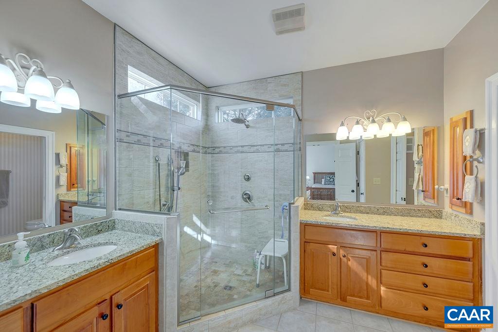 1990 River Inn Lane Charlottesville, VA 22901 - Photo 20 of 48 a bathroom with a granite countertop sink mirror and a shower