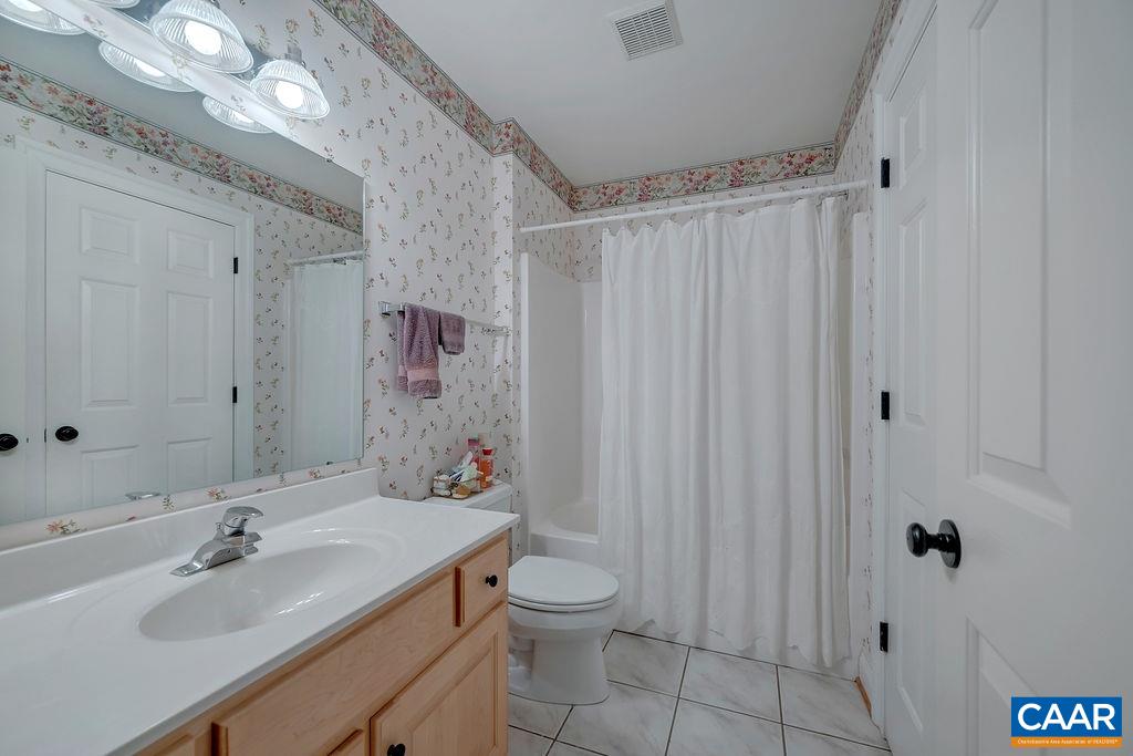 1990 River Inn Lane Charlottesville, VA 22901 - Photo 36 of 48 a bathroom with a granite countertop sink toilet a mirror a vanity and shower
