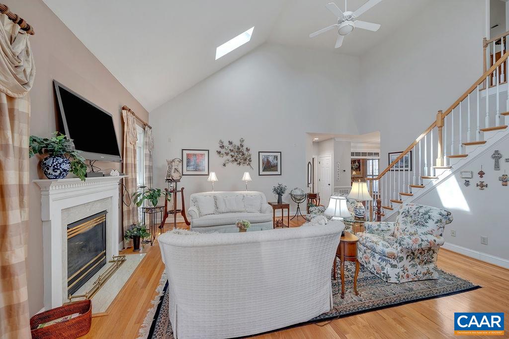 1990 River Inn Lane Charlottesville, VA 22901 - Photo 6 of 48 a living room with furniture a fireplace and a flat screen tv