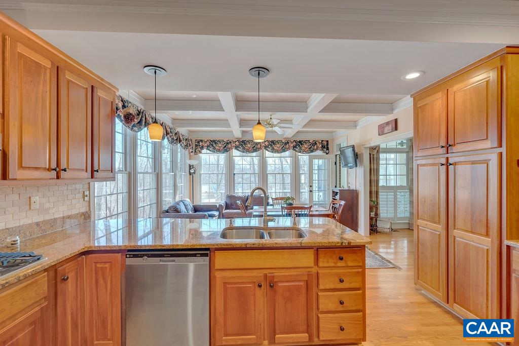 1990 River Inn Lane Charlottesville, VA 22901 - Photo 10 of 48 a open kitchen with stainless steel appliances granite countertop a refrigerator a sink dishwasher and wooden cabinets with wooden floor