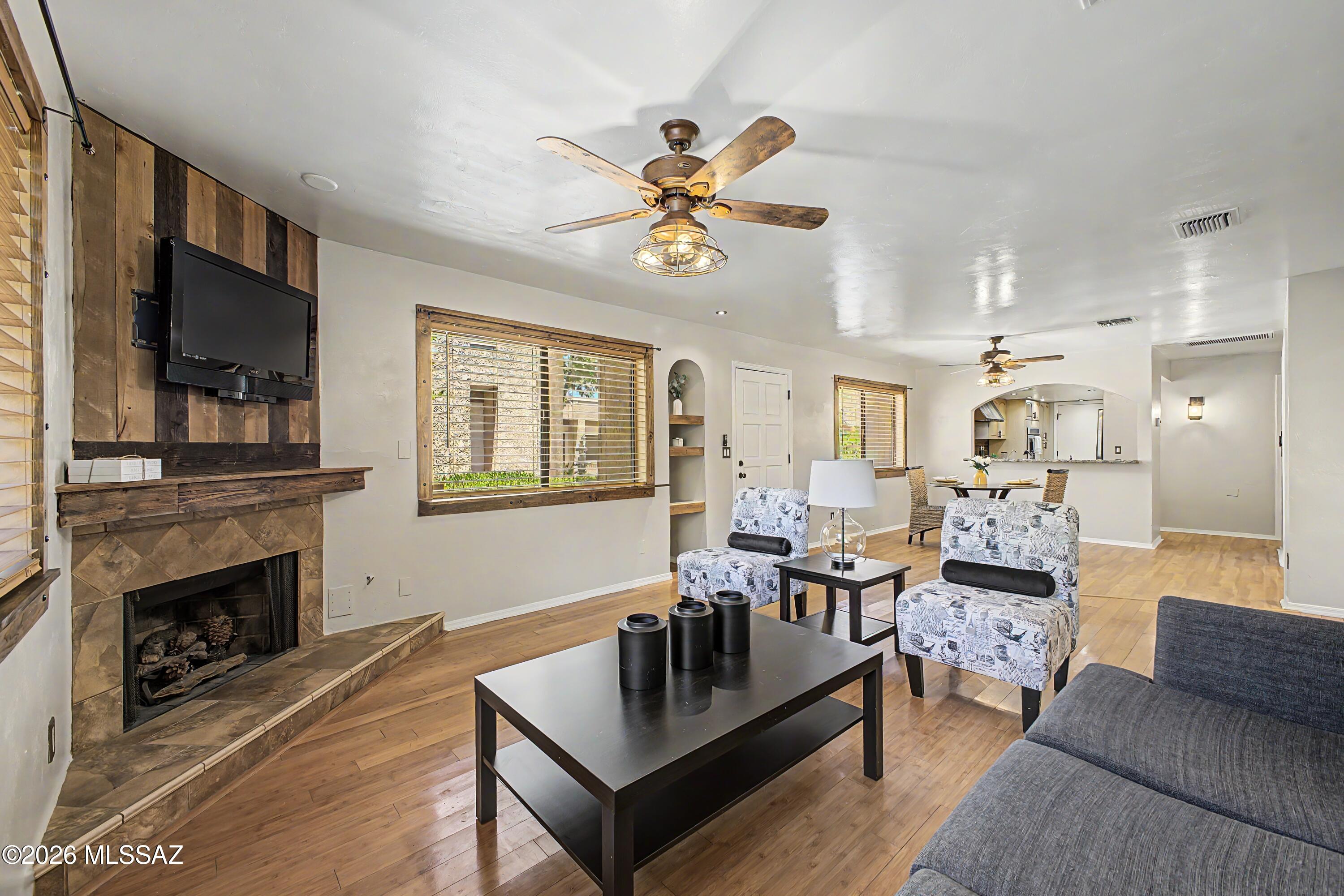 3781 East Edison Street Tucson, AZ 85716 - Photo 1 of 28 a living room with furniture a flat screen tv and a fireplace