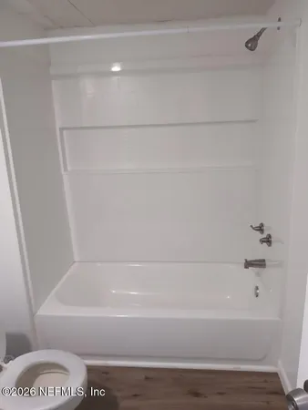 a bathroom with a bathtub and a toilet