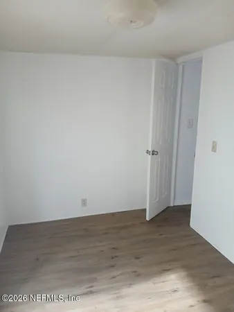 an empty room with wooden floor