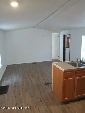 a view of a room with wooden floor