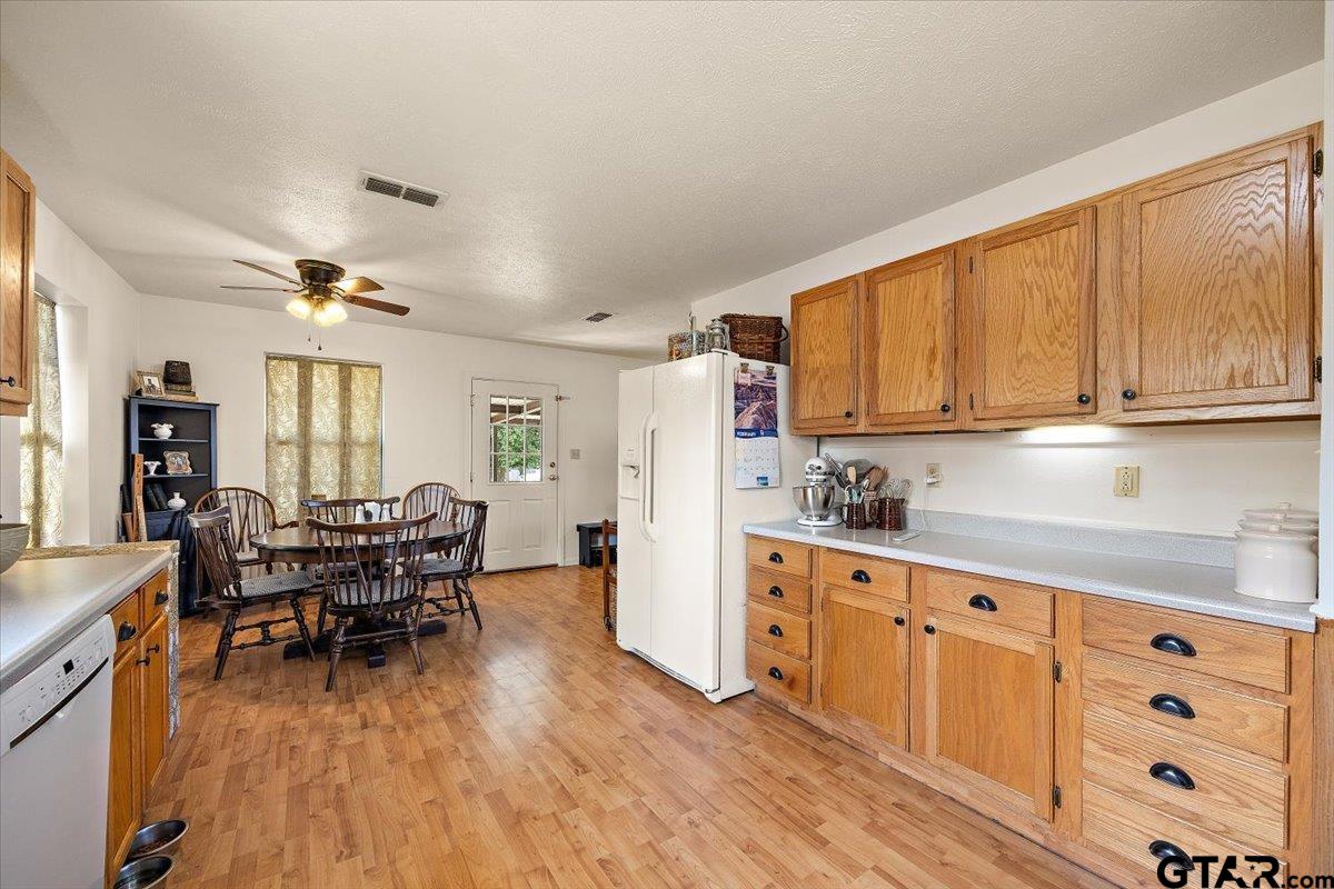 110 Earl Street Rusk, TX 75785 - Photo 11 of 29 a kitchen with stainless steel appliances granite countertop a refrigerator a stove top oven a dining table and chairs with wooden floor