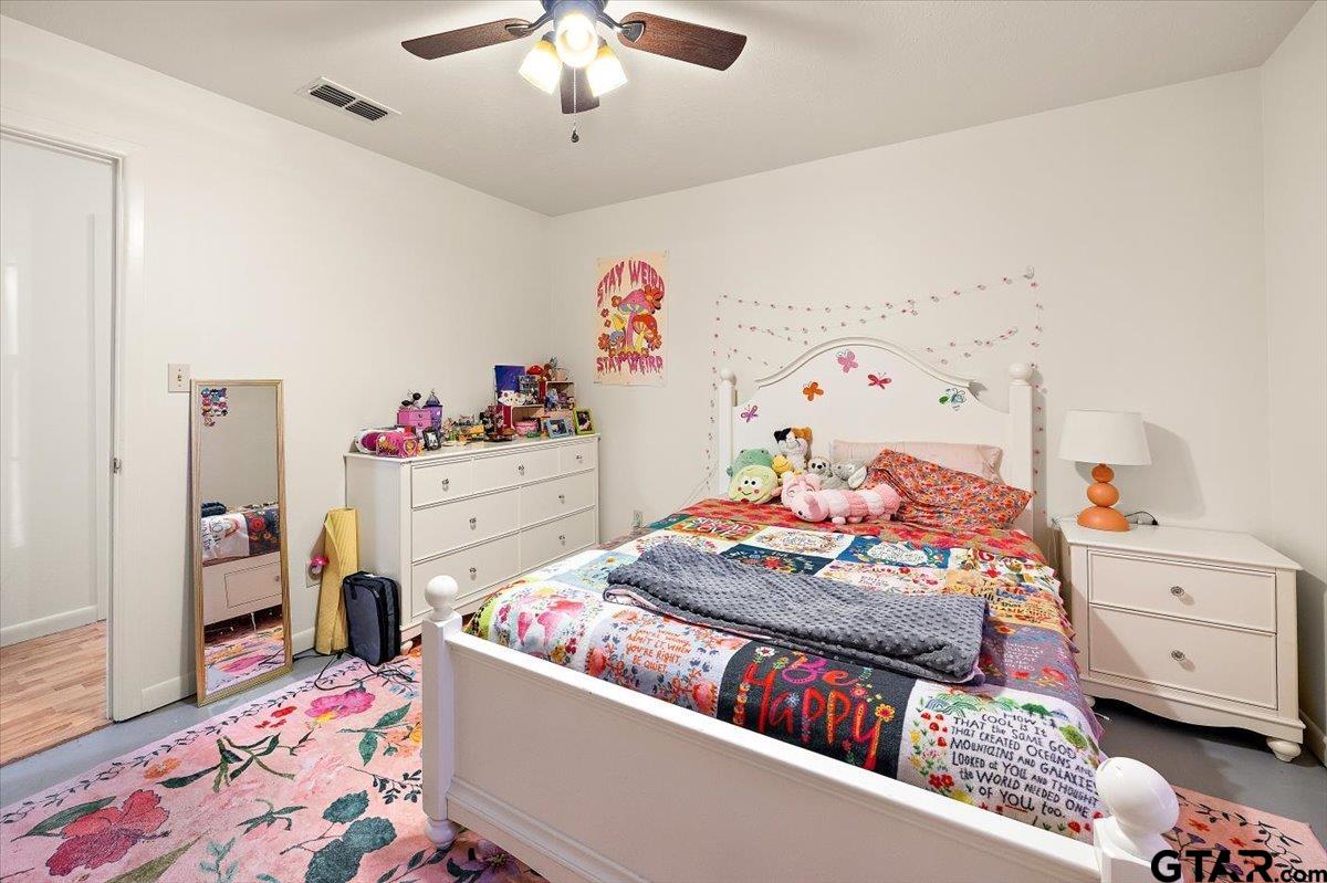 110 Earl Street Rusk, TX 75785 - Photo 13 of 29 a bedroom with a bed and wooden floor