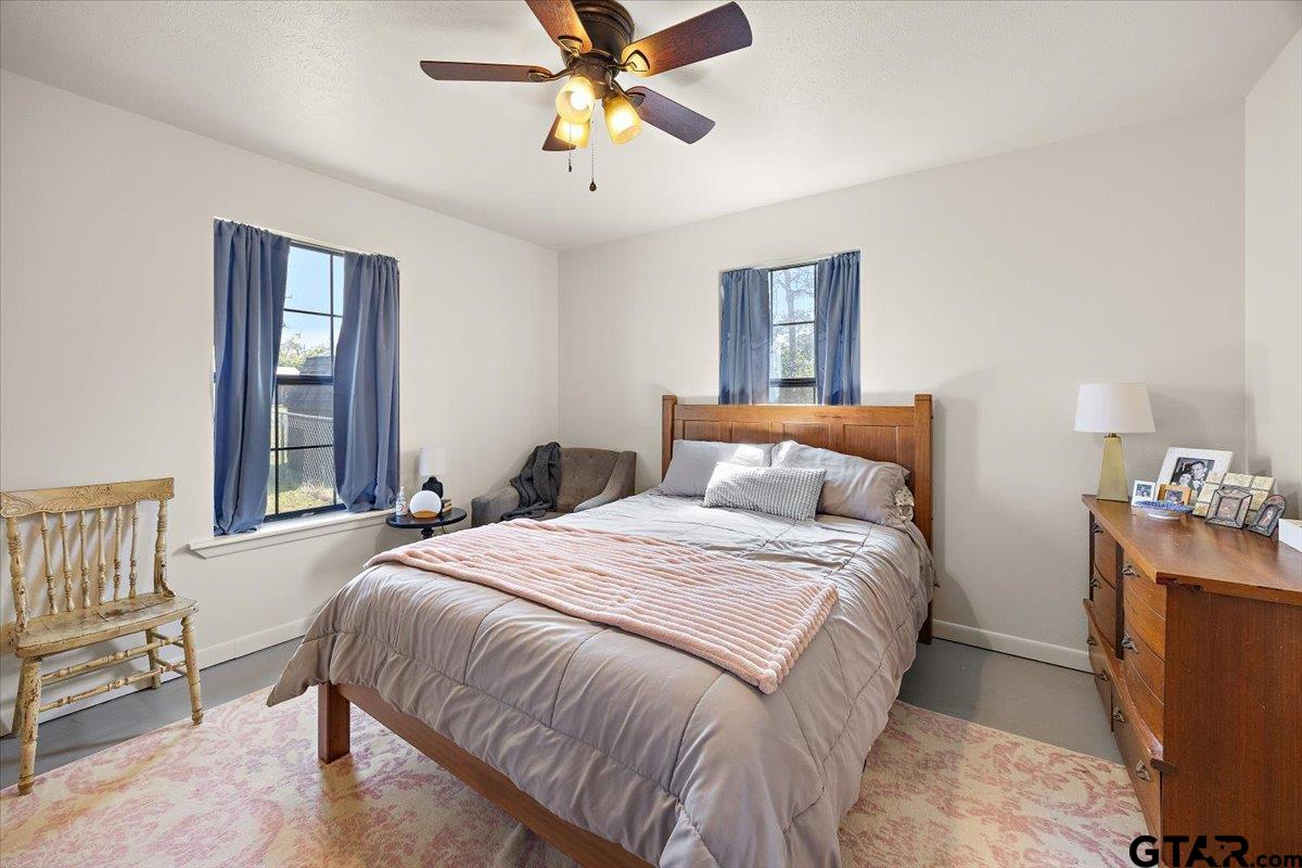 110 Earl Street Rusk, TX 75785 - Photo 15 of 29 a bedroom with a bed and a chandelier