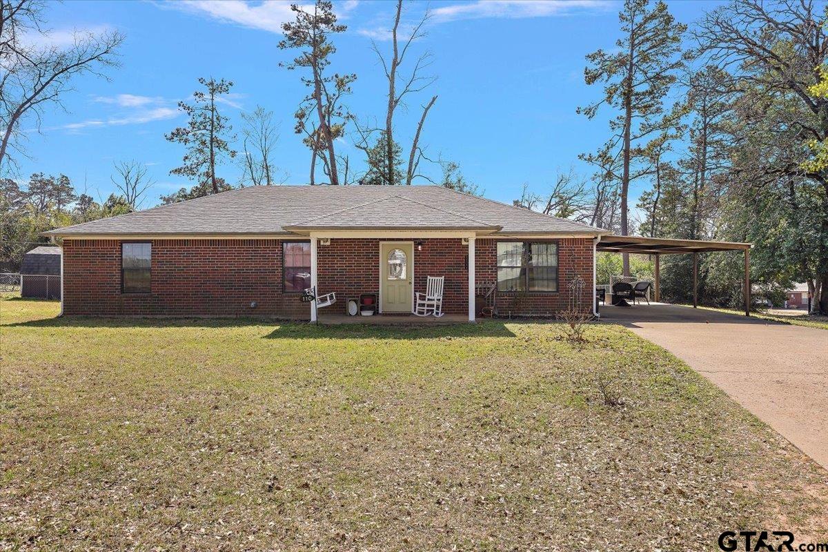 110 Earl Street Rusk, TX 75785 - Photo 26 of 29 a front view of a house with a garden