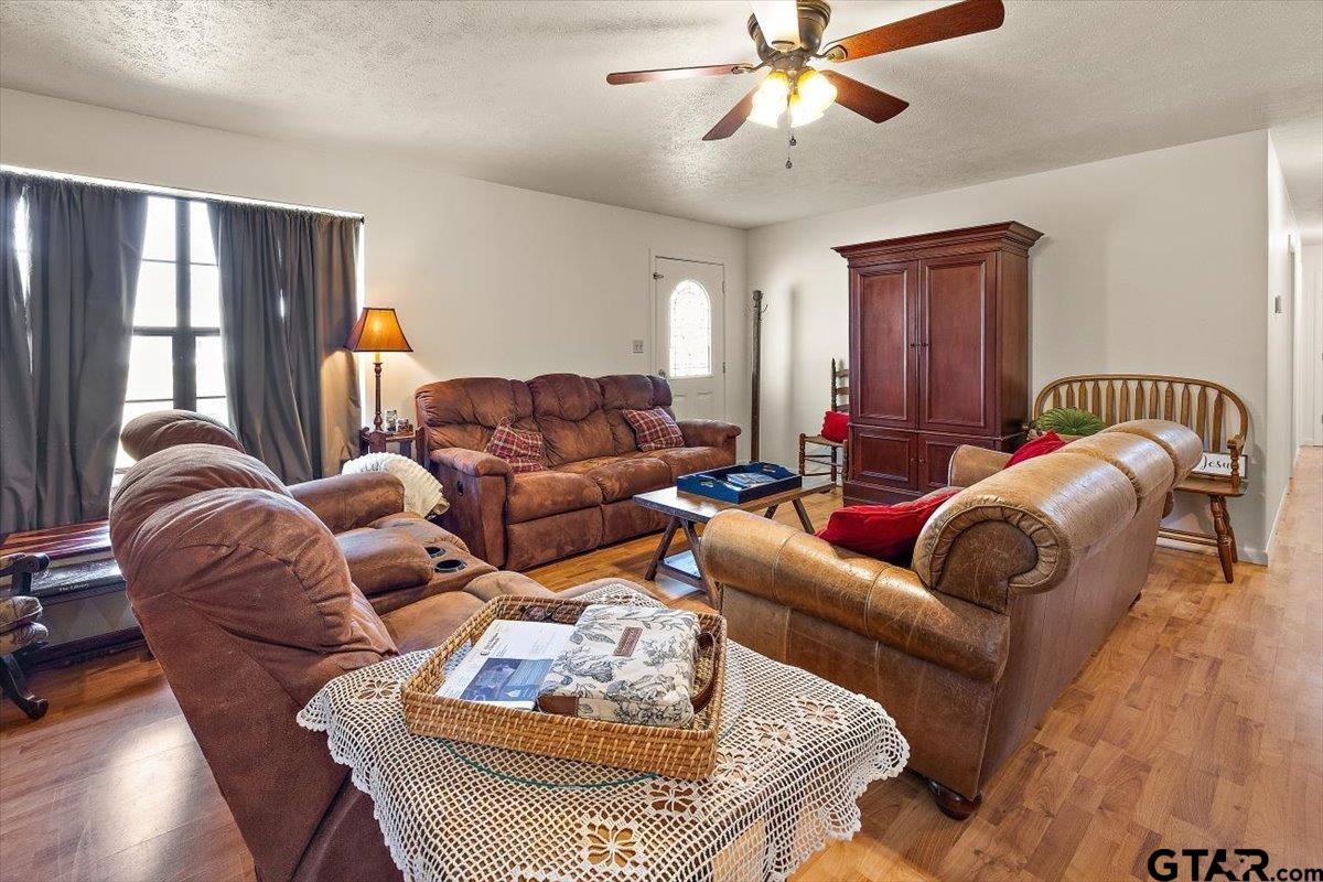 110 Earl Street Rusk, TX 75785 - Photo 7 of 29 a living room with furniture ceiling fan and a rug
