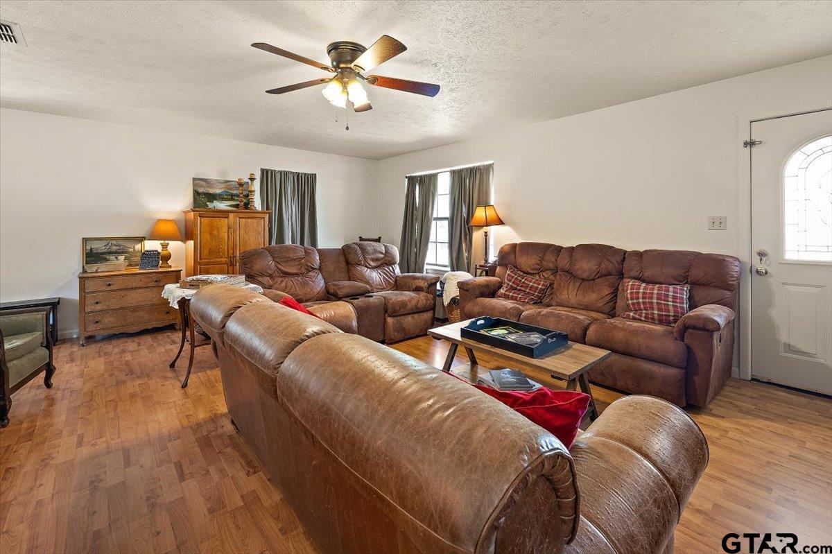 110 Earl Street Rusk, TX 75785 - Photo 7 of 29 a living room with furniture a ceiling fan a lamp and a window