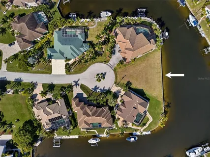 an aerial view of a house with a yard and pool