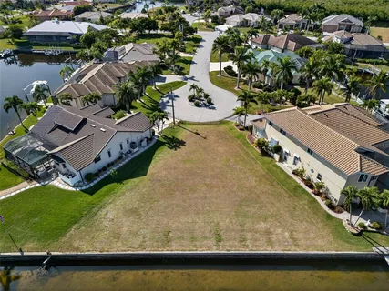 an aerial view of residential houses with outdoor space and swimming pool