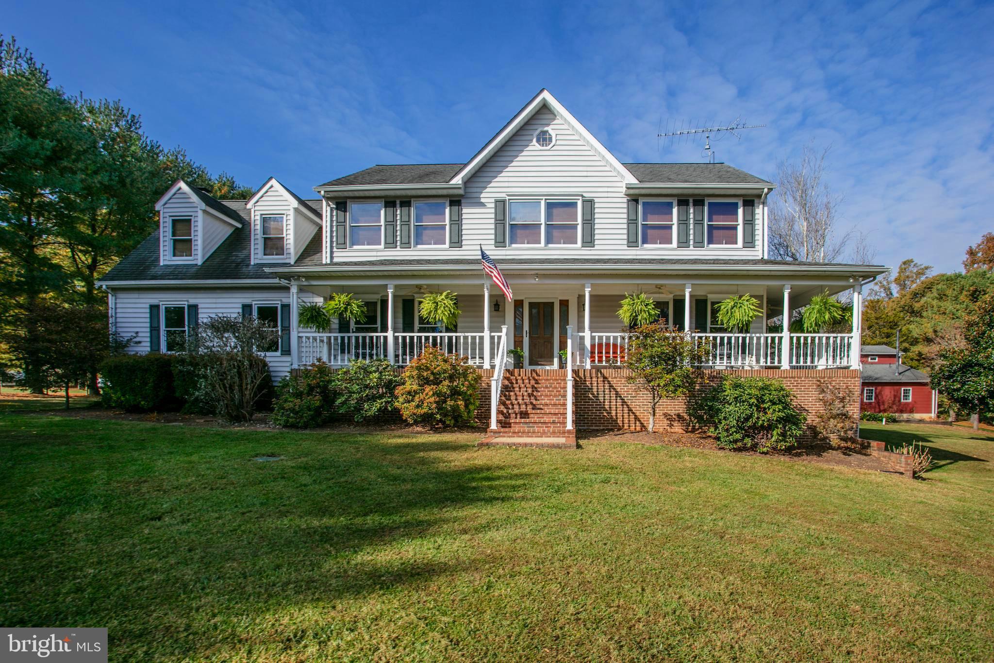 a front view of a house with a garden and porch