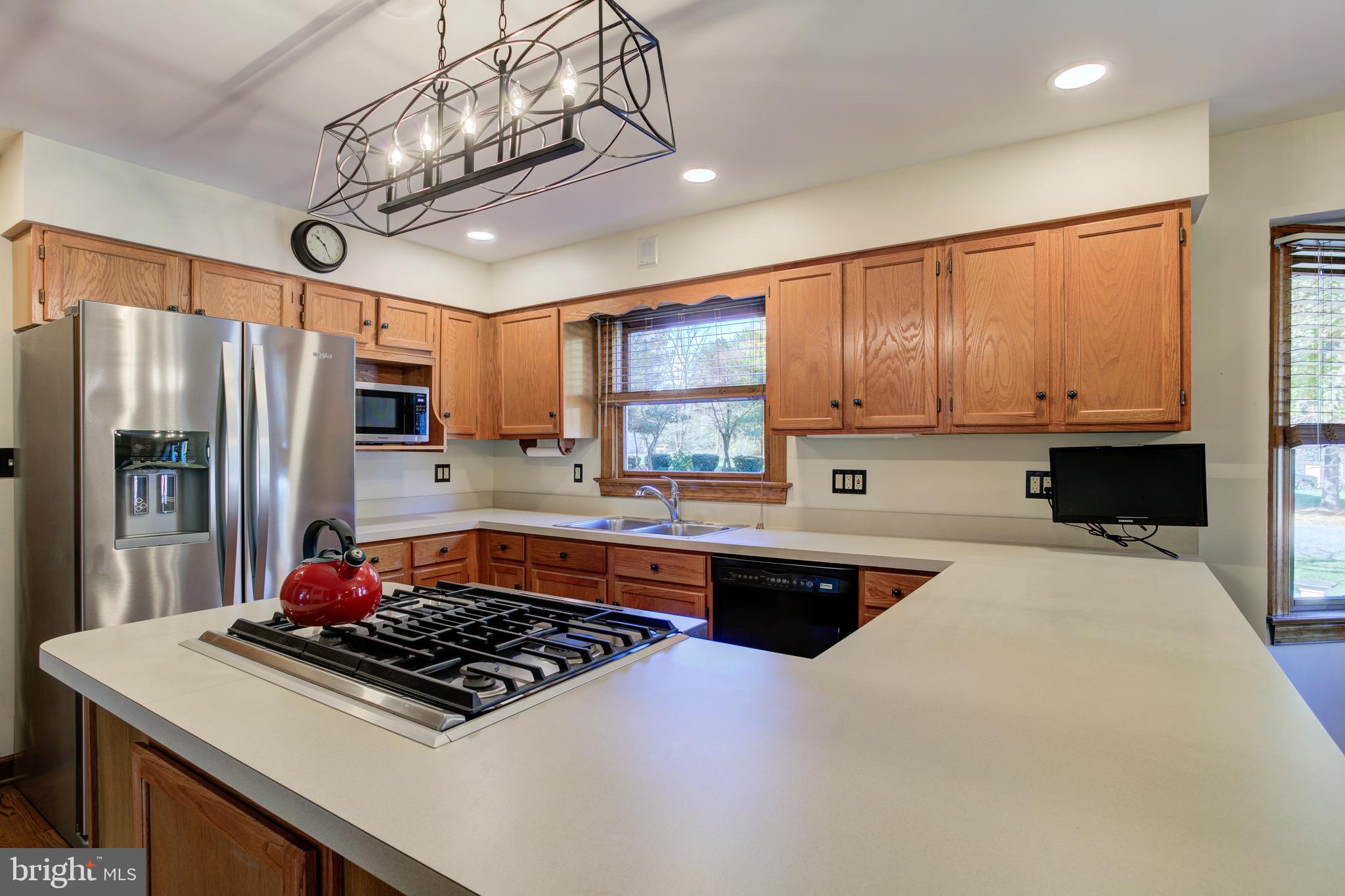 12117 Salem Church Road King George, VA 22485 - Photo 16 of 34 a kitchen with stainless steel appliances granite countertop a sink stove and refrigerator