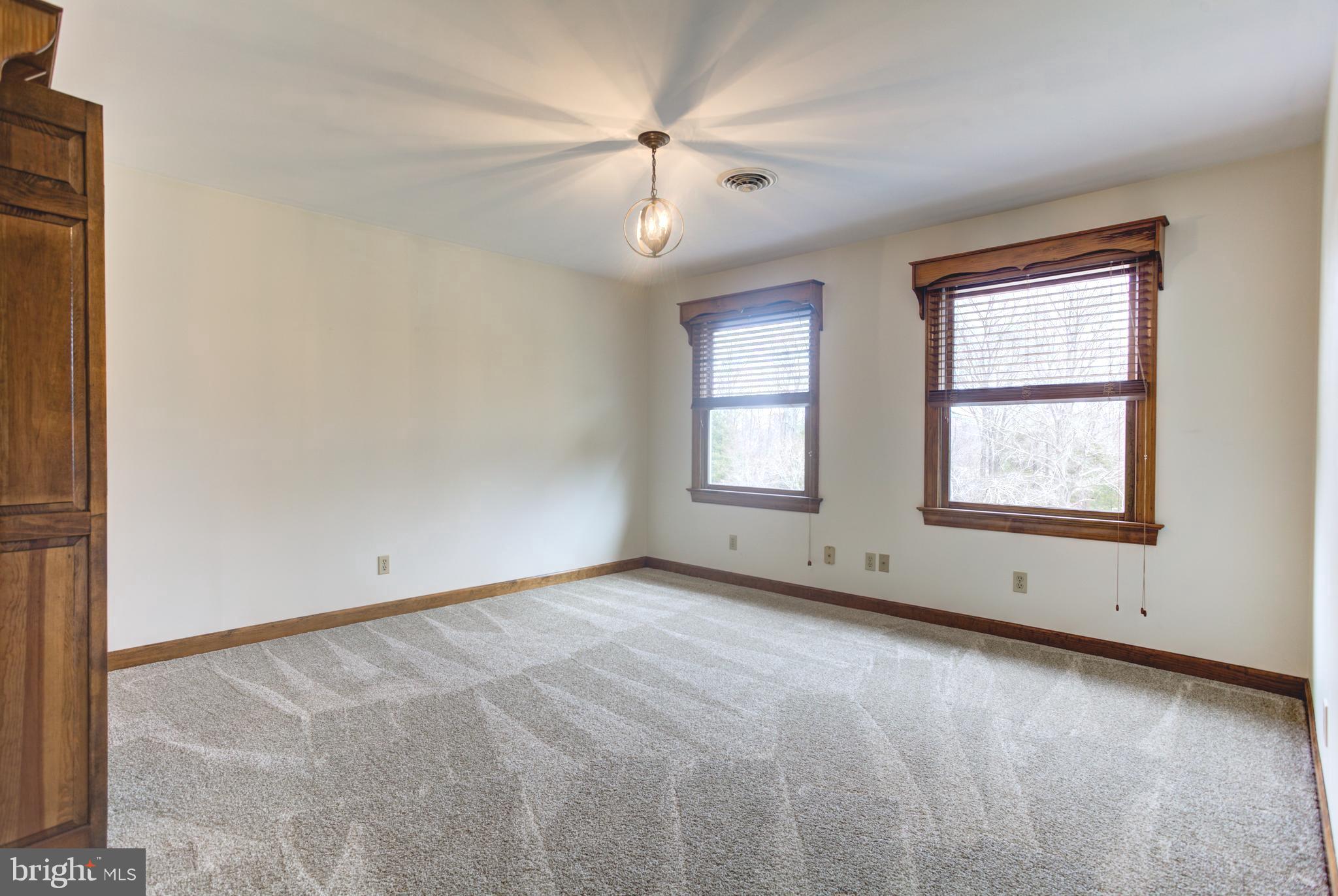 12117 Salem Church Road King George, VA 22485 - Photo 22 of 34 an empty room with windows and ceiling fan