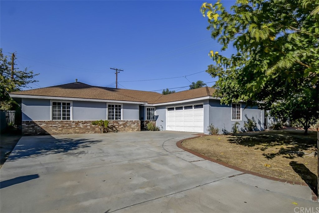 10711 Cass Street Riverside, CA 92505 - Photo 1 of 1 a front view of a house with yard and parking space