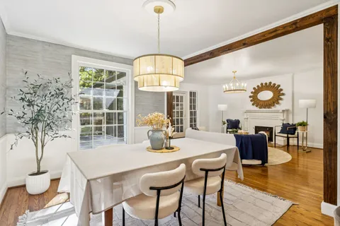 a dining room with furniture and window