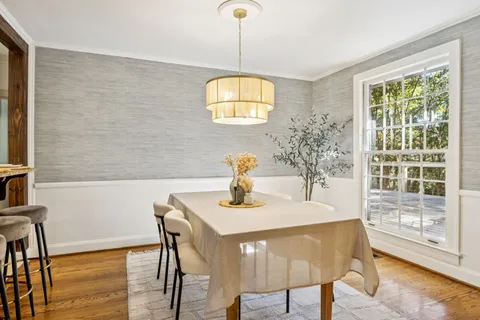 a kitchen with granite countertop a sink window and cabinets
