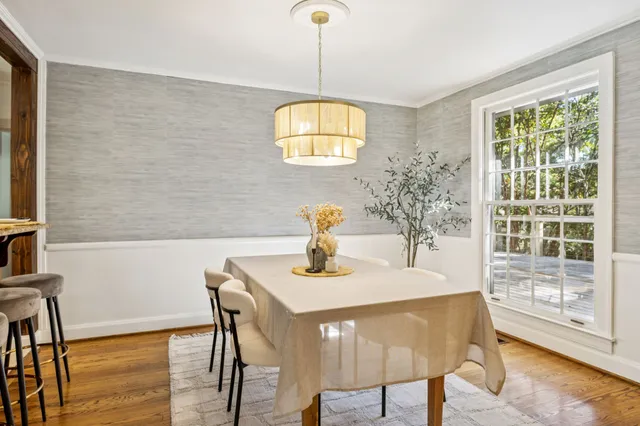 a kitchen with granite countertop a sink window and cabinets