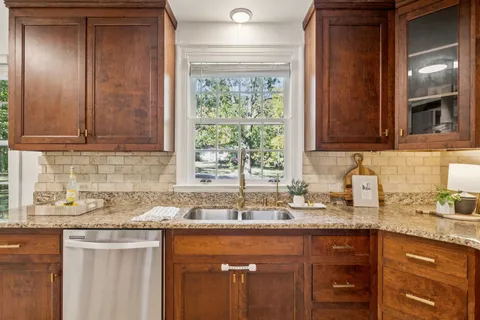 a kitchen with a stove refrigerator and a sink