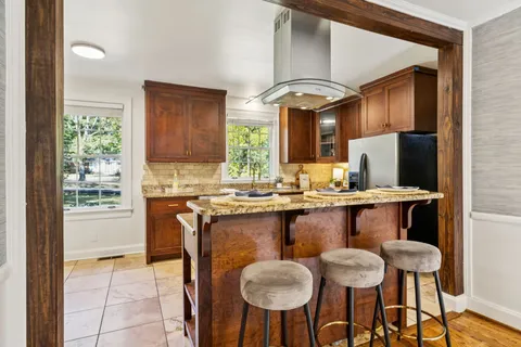 a kitchen with stainless steel appliances granite countertop a refrigerator and a sink