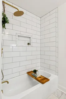 a living room with a fireplace and wooden floor