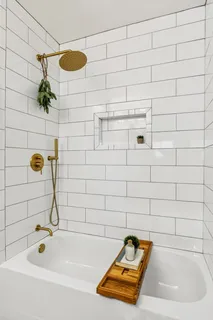 a spacious bedroom with a bed and a rug