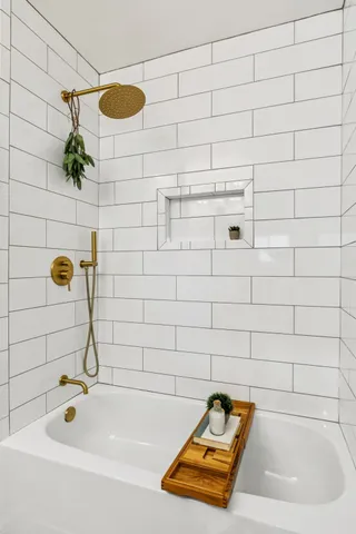 a spacious bedroom with a bed and a rug