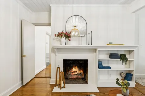 a bathroom with a sink a mirror and next to a window