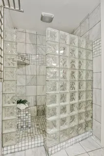 an empty room with wooden floor exposed radiator and windows