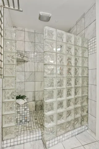 an empty room with wooden floor exposed radiator and windows