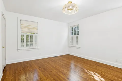 a view of a house with backyard and a tree
