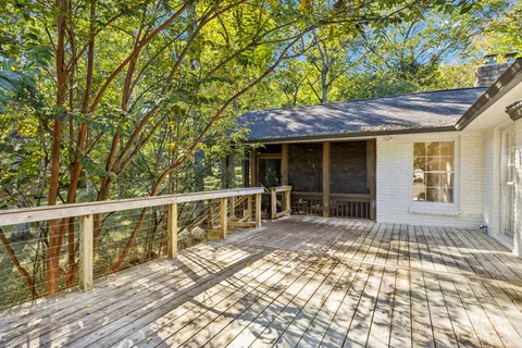 a front view of a house with a yard and green space
