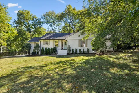 a house with swimming pool in front of it